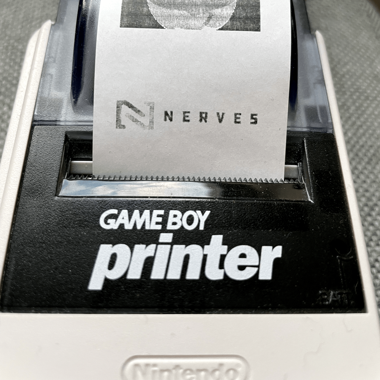 Close up of the printed Nerves logo coming out of the printer.